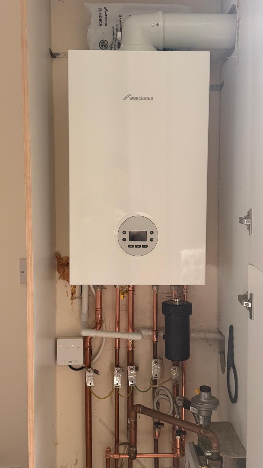 Worcester Bosch combi boiler installed in a cupboard with a magnetic filter, Livingston