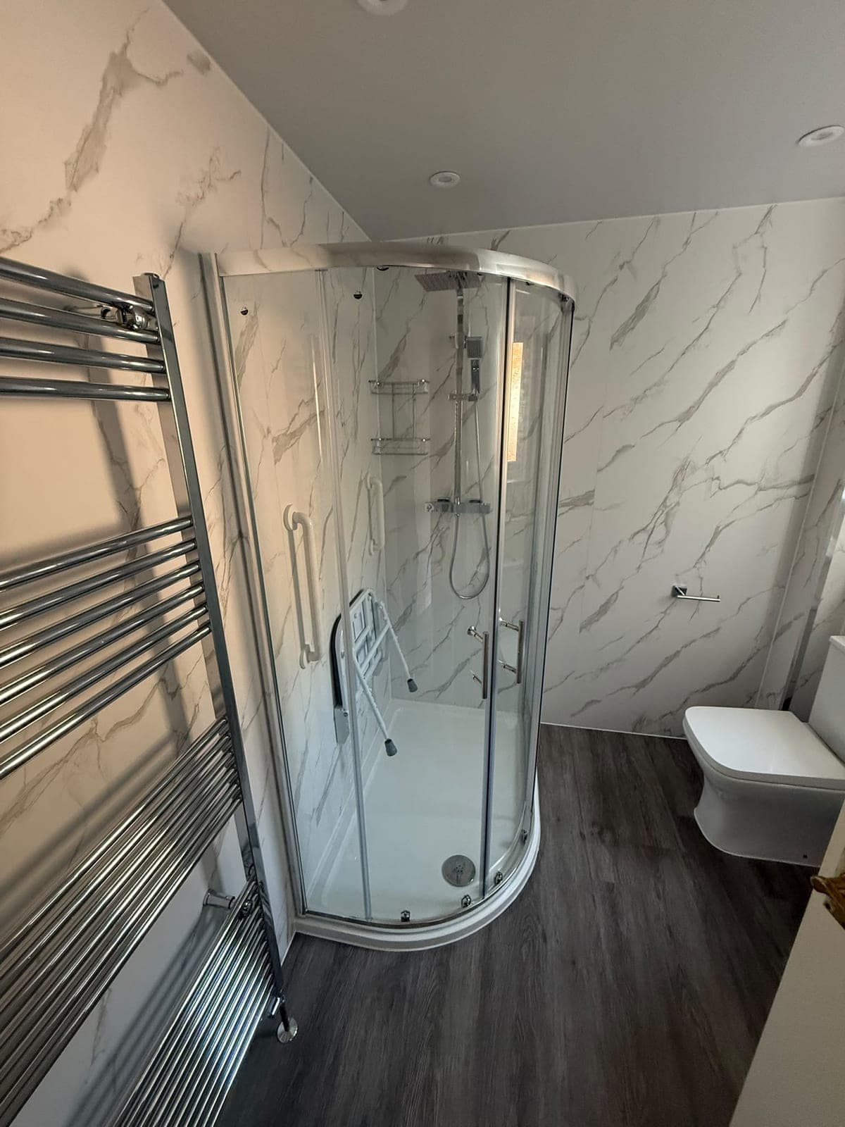 Easy-access shower room with a quadrant enclosure, fold-down seat and grab rails, Edinburgh