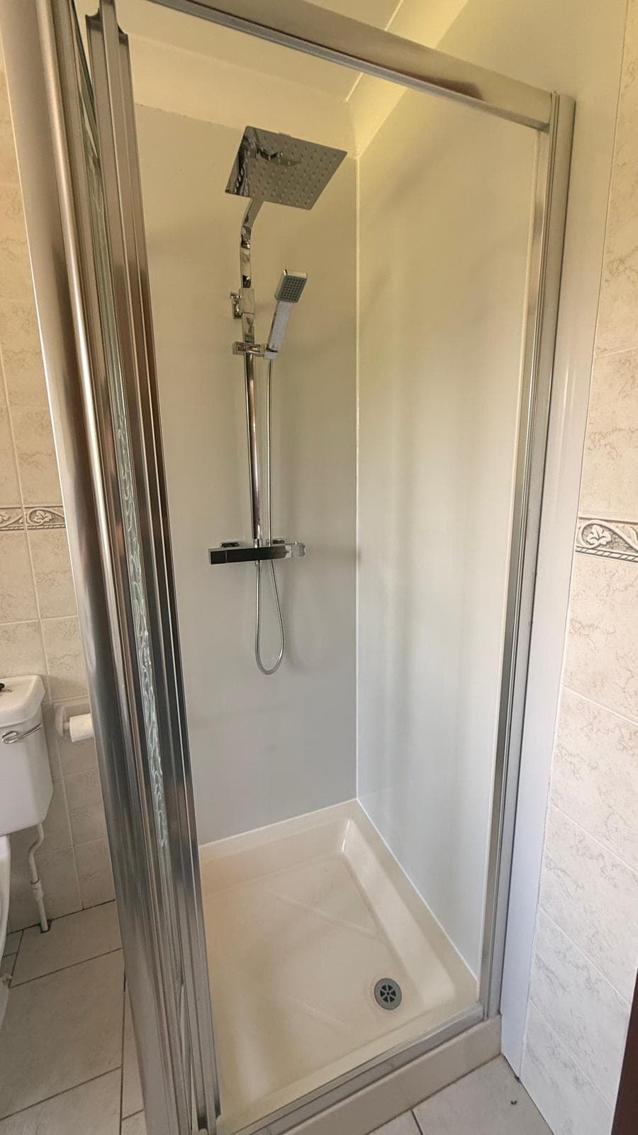 Replaced shower cubicle with white panels and a thermostatic rainfall shower, Kirkcaldy